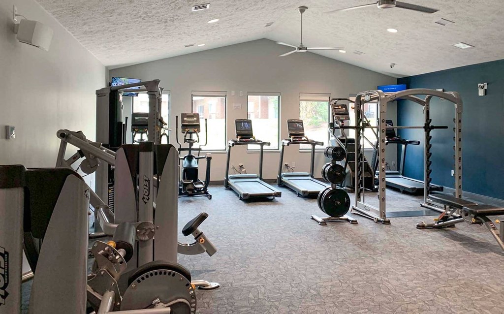 a gym with various weights and cardio equipment in a large room