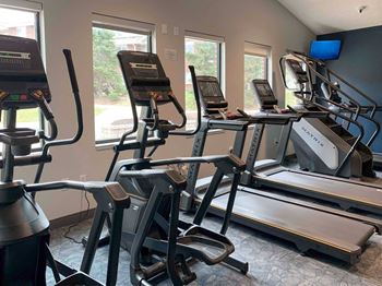 a group of exercise machines in a gym