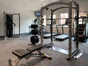 a gym with weights and other exercise equipment in a room