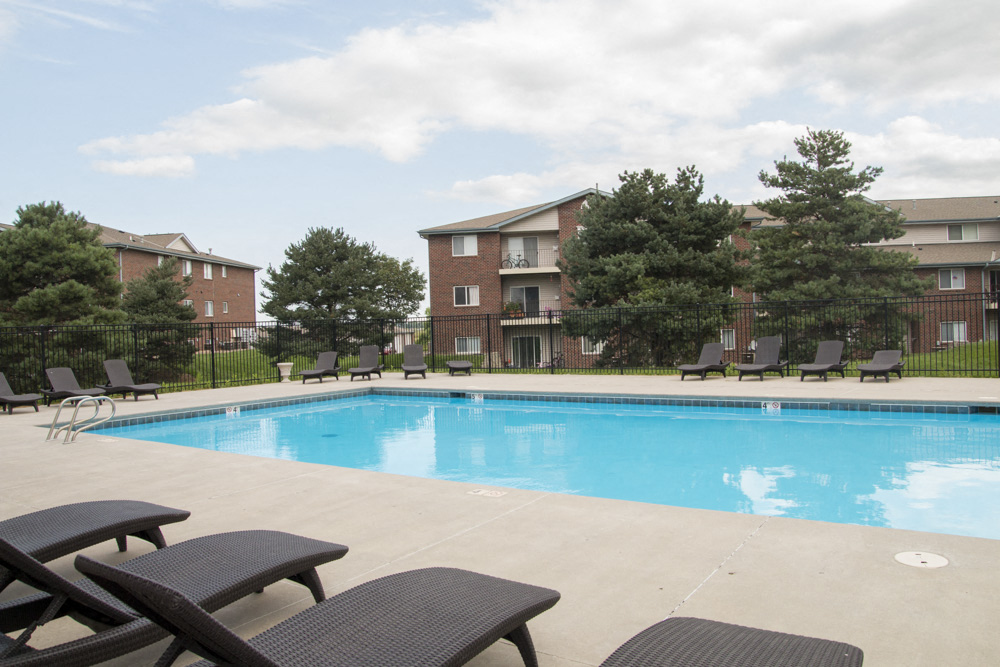 Swimming pool with lounge chairs at Northridge Heights apartments in North Lincoln