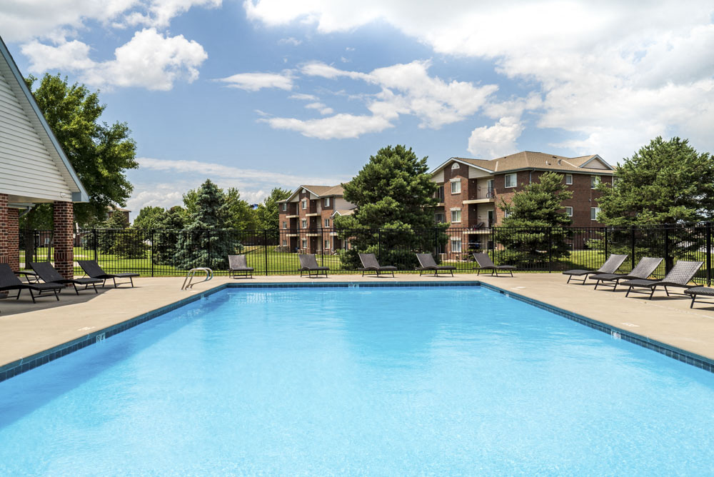 Pool with lounge chairs at Northridge Heights Apartments!