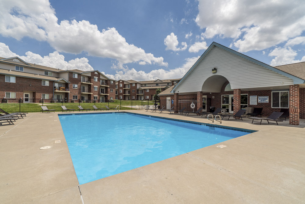 Pool with lounge chairs at Northridge Heights Apartments!