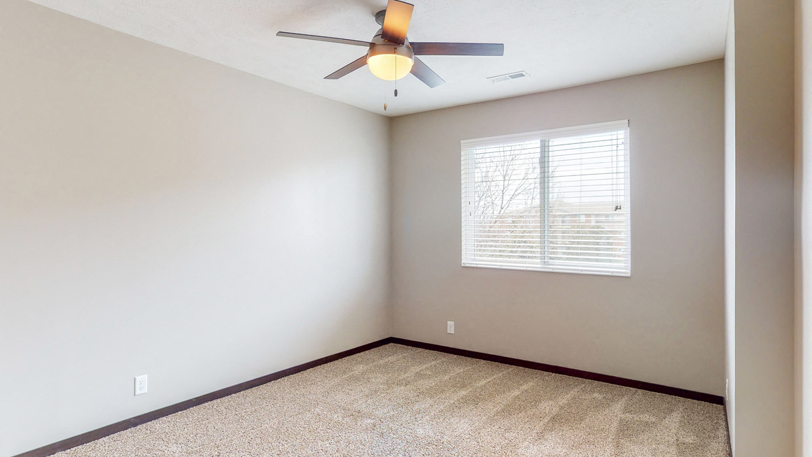 Large renovated bedroom with ceiling fan at Northridge Heights apartments in Lincoln