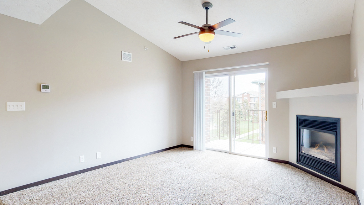 Renovated living room with high ceilings and gas fireplace at Northridge Heights in Lincoln