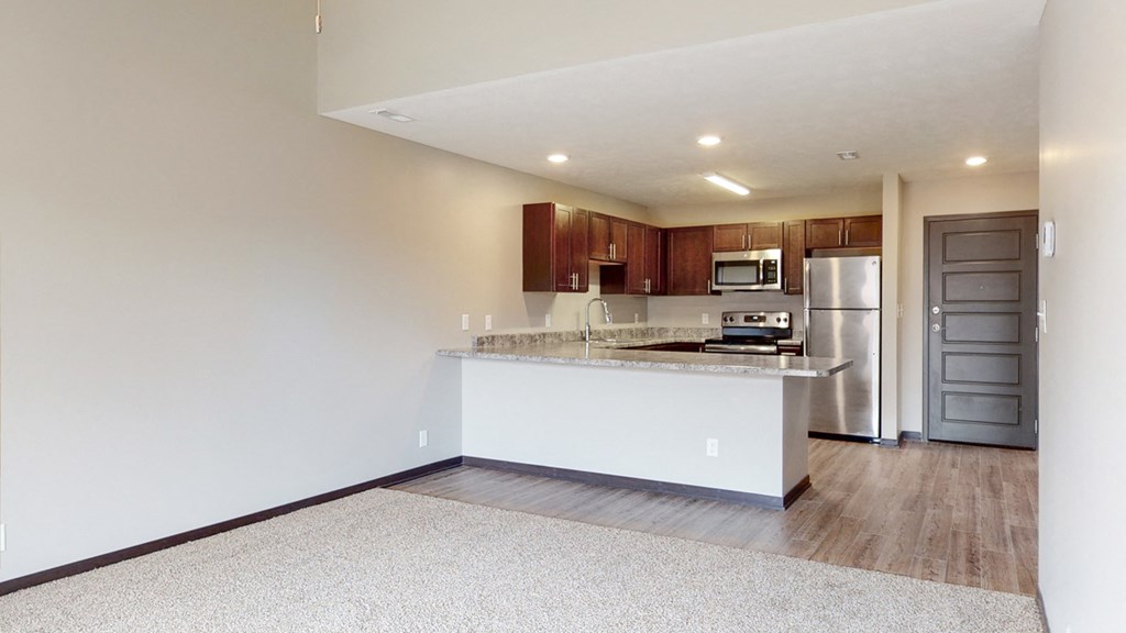 Open dining and living area with carpeted floors at Northridge heights in lincoln nebraska