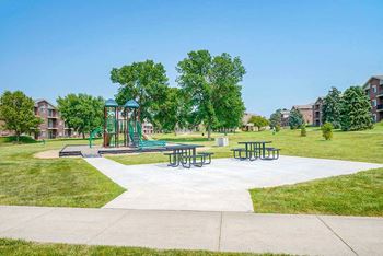 Children's playground with a climbing structure next to a picnic area