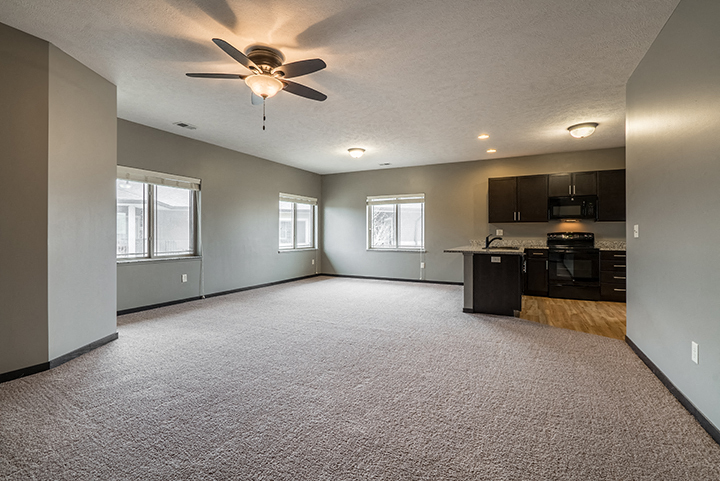 Interiors- Large living space with kitchen at The Villas of Omaha at Butler Ridge in Omaha Nebraska