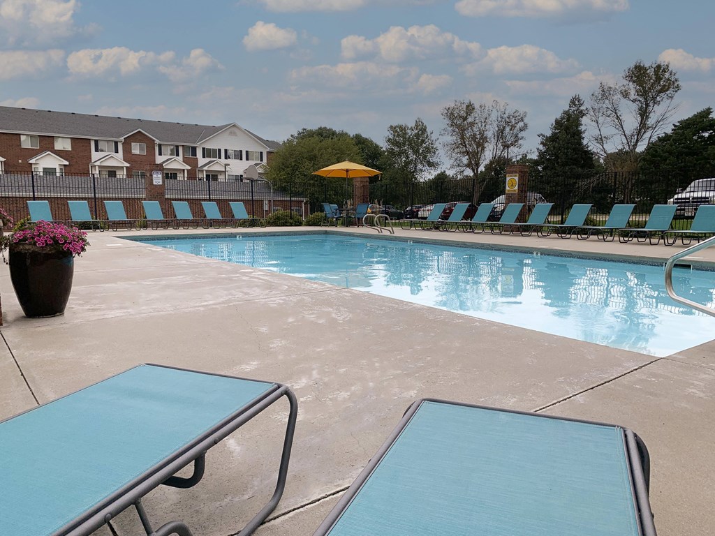Resort style swimming pool with sun tanning loungers at Ridge Pointe Villas in South Lincoln Nebraska
