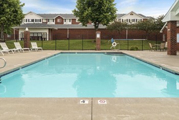 Resort style swimming pool with sun tanning loungers at Ridge Pointe Villas in South Lincoln Nebraska - Photo Gallery 41