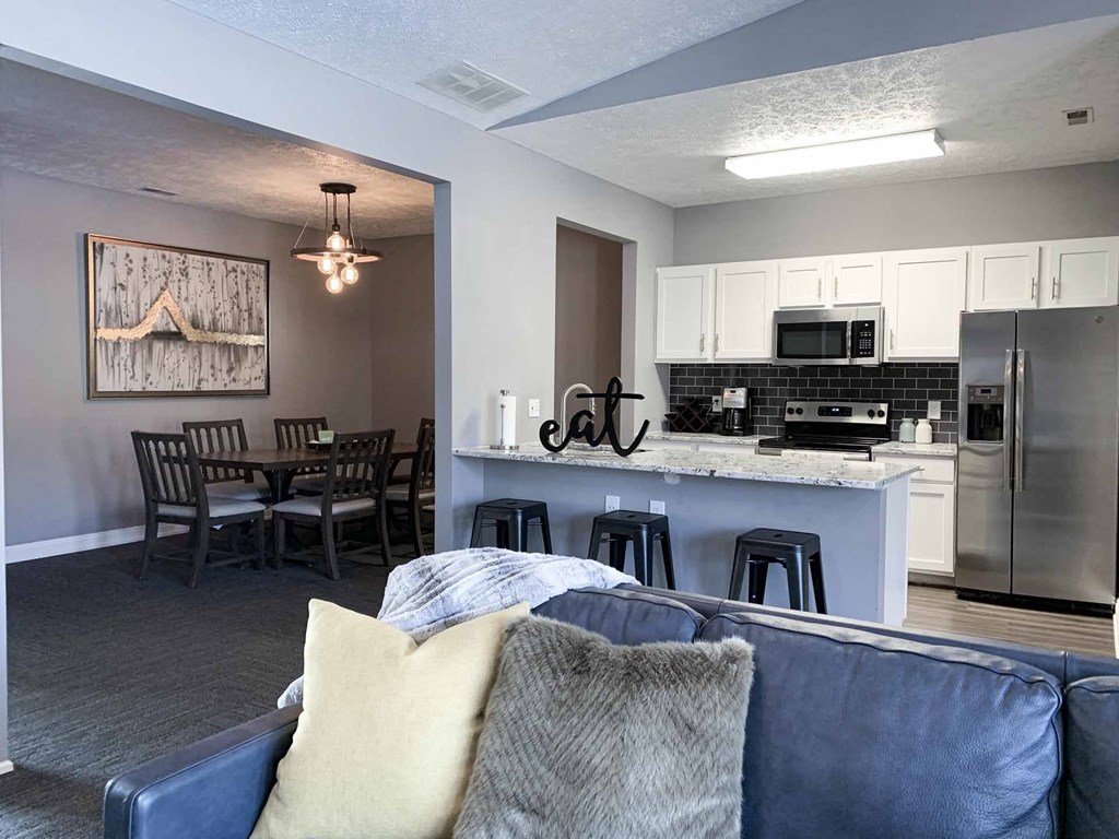 clubhouse lounge space and kitchen with a couch and a table