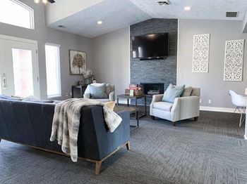 a clubhouse community room with a couch and a tv