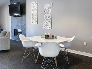 a dining room with a table and chairs and a fireplace