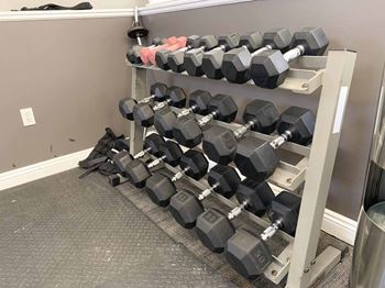 weight rack full of dumbells