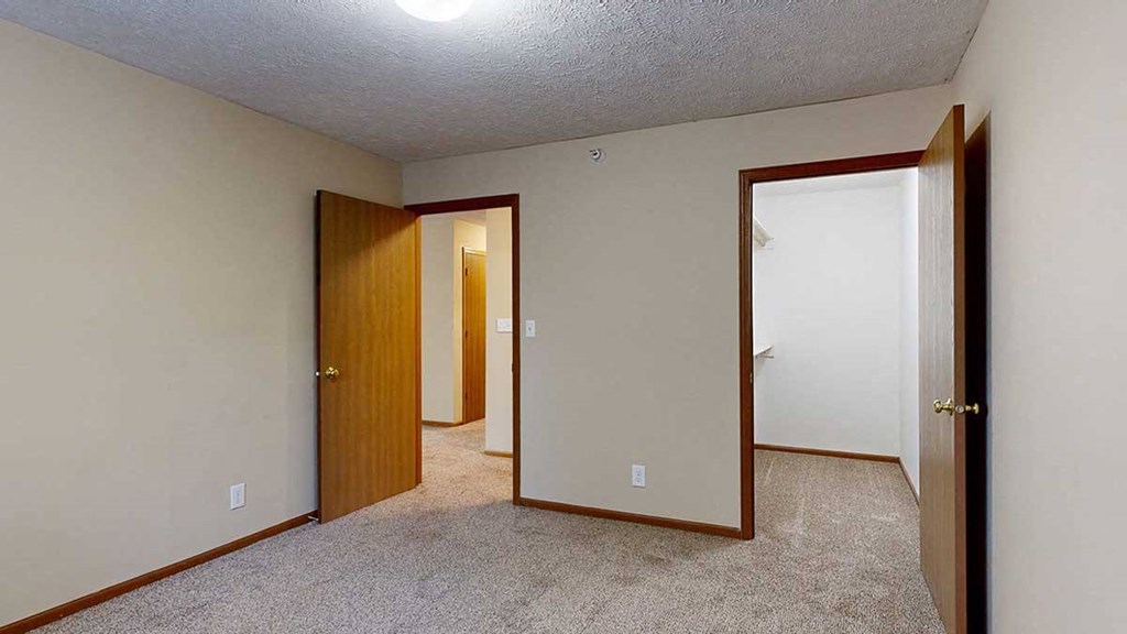 a bedroom with an attached large walk-in closet