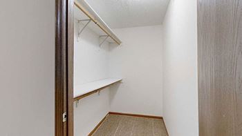 a walk-in closet with built-in shelves and hanging space for ample storage