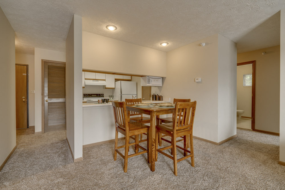Dining area and kitchen view at Pine Lake Heights Apartments