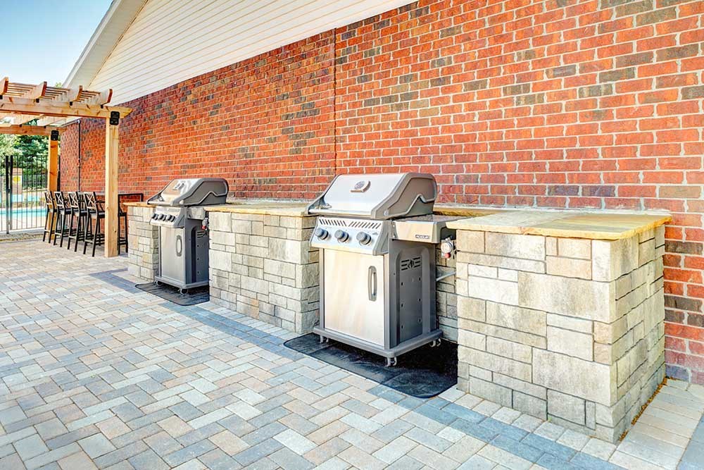 Two outdoor grilling stations with stone counters, perfect for grilling up your favorite recipes.