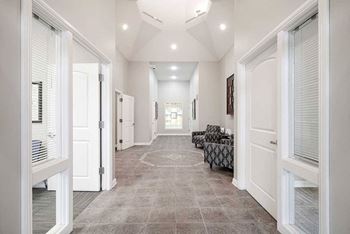an open lobby space with an office space off to each side