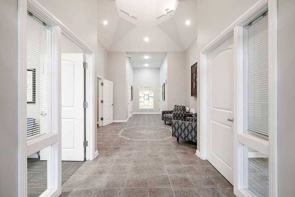 an open lobby space with an office space off to each side