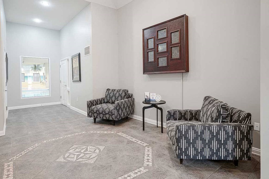 a clubhouse lobby with two chairs