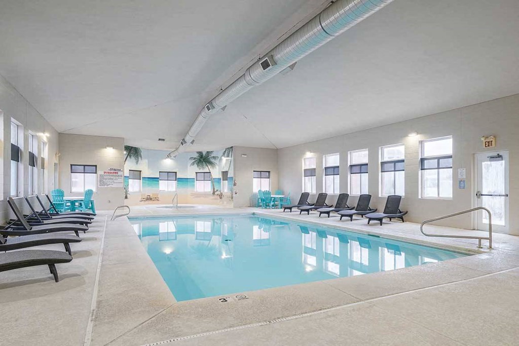 an indoor swimming pool with rows of chairs