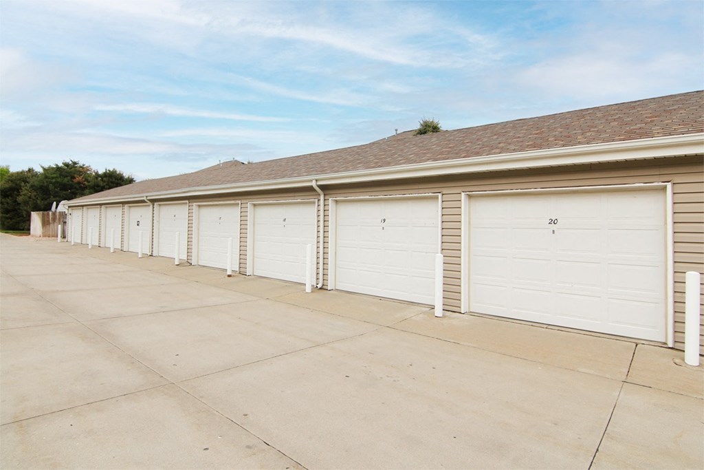 A row of nine garages with white garage doors