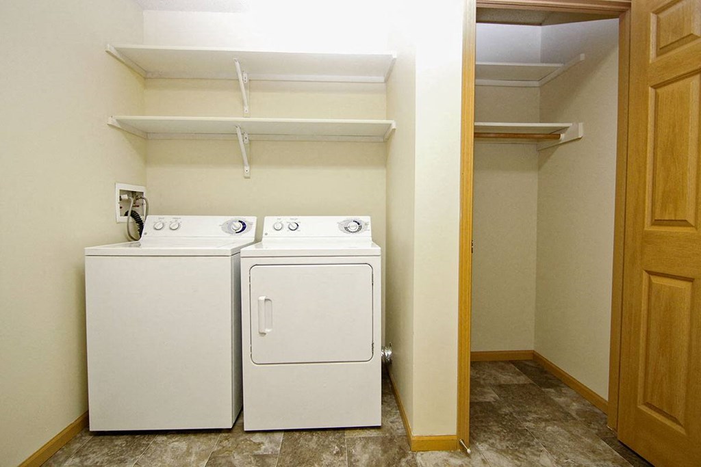 A small laundry room with a washer and dryer.