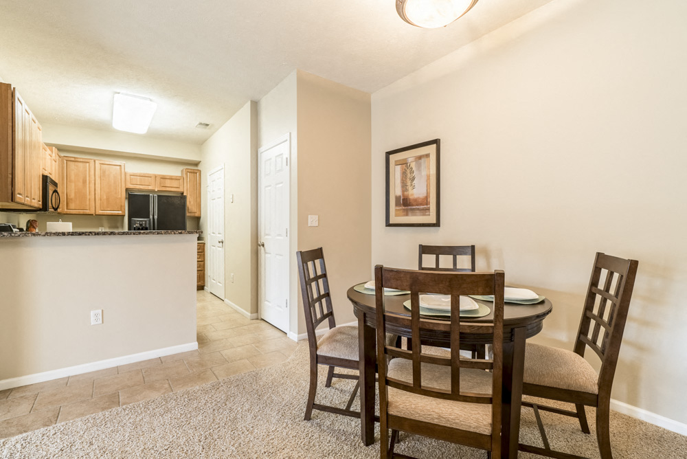 Interiors-Dining room with kitchen view at Ridge Pointe Villas