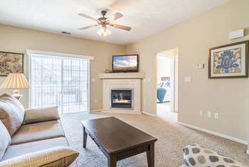 Interiors-Living room view of 1-bedroom townhome with balcony at Ridge Pointe Villas - Photo Gallery 3