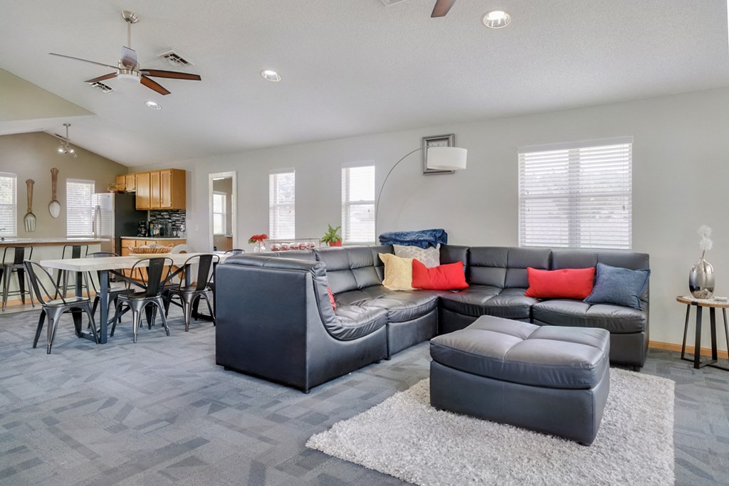 Common area with lounge area and kitchen in the clubhouse at Skyline View apartments