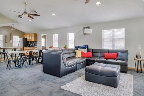 Common area with lounge area and kitchen in the clubhouse at Skyline View apartments