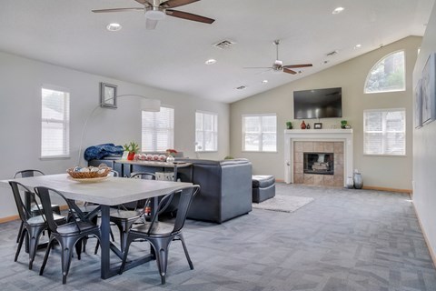 Common area with lounge area, fireplace and kitchen in the clubhouse at Skyline View apartments