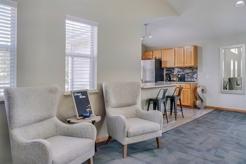 Lounge space with chairs near the kitchen in the clubhouse at Skyline View