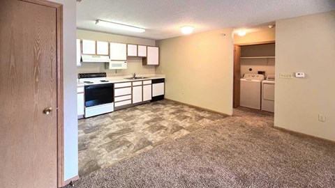 a kitchen with white cabinets and appliances