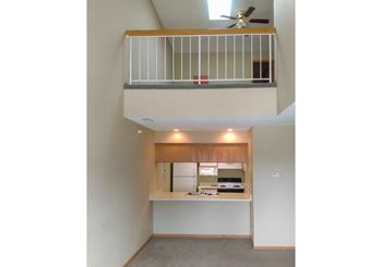a loft area balcony over a kitchen