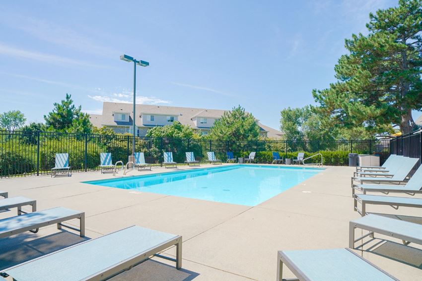 Swimming pool Swimming pool with lounge chairs for sunbathing