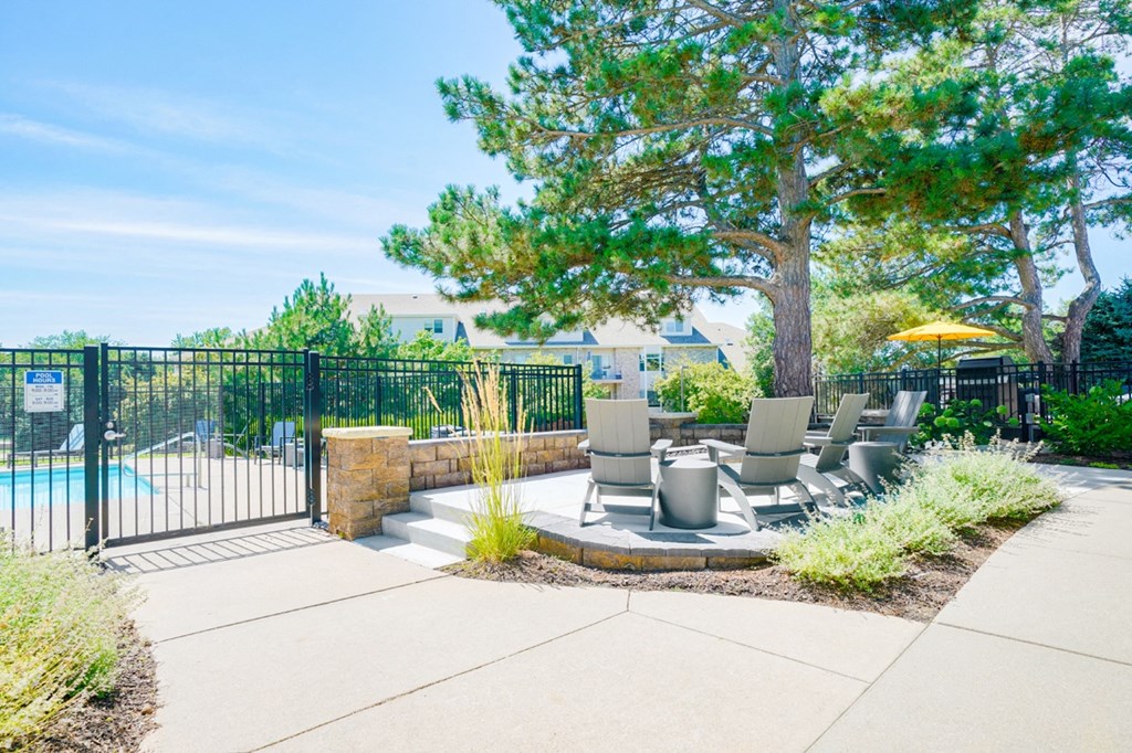 Fire pit with chairs outside of the gated community pool