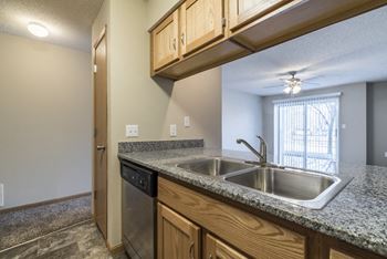 A kitchen with granite countertops and stainless steel appliances.