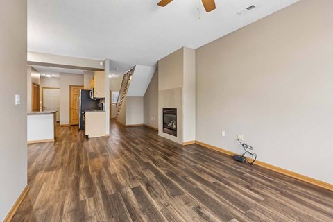 A room with wood flooring and a fireplace.