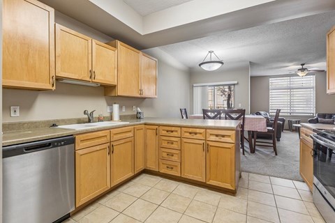 A kitchen with wooden cabinets and a dining table.