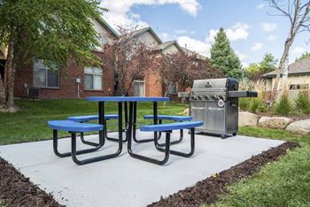 Picnic table with outdoor grill  at Southwind Villas in southwest Omaha in La Vista, NE, 68128