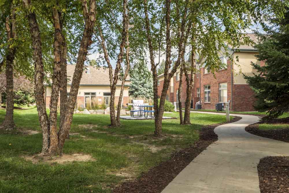 Scenic courtyard with mature trees and walking path  at Southwind Villas in southwest Omaha in La Vista, NE, 68128