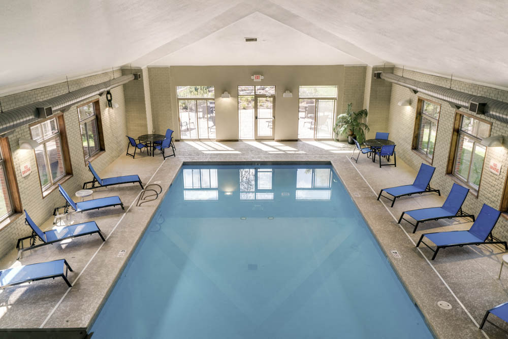 Indoor swimming pool with poolside chairs at Southwind Villas in southwest Omaha in La Vista, NE, 68128