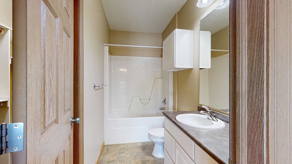 a bathroom with a toilet and a sink and a shower