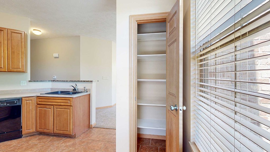 a kitchen with a pantry next to a window