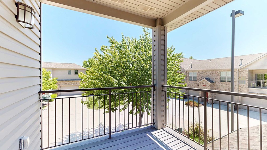 the view from the corner balcony with a tree that provides privacy