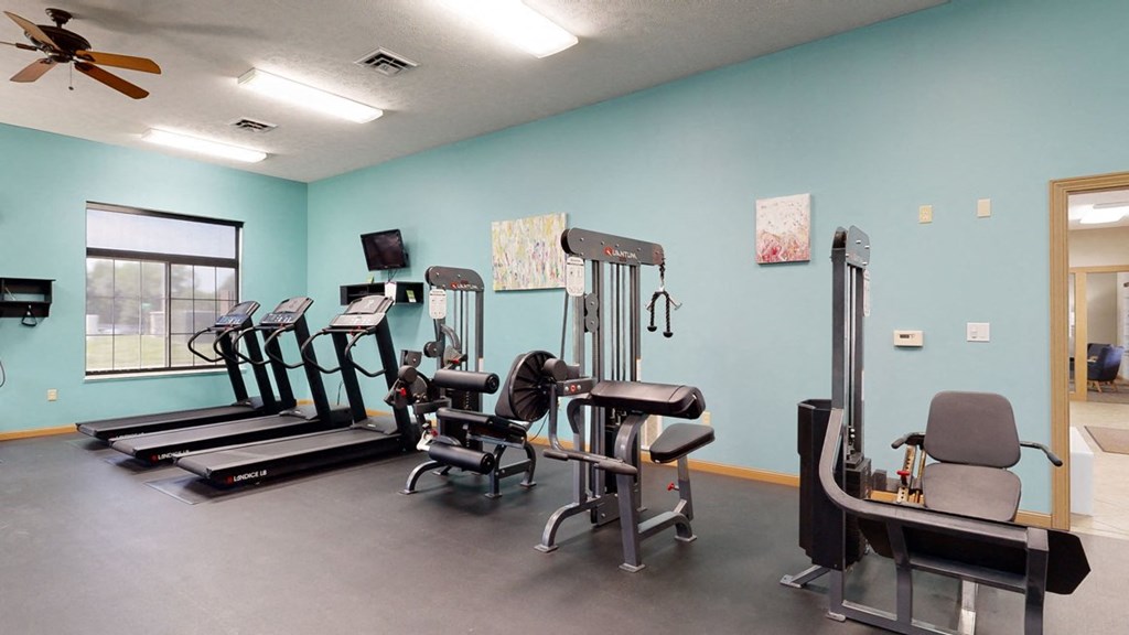 24 hour fitness center includes a treadmill, elliptical and many workout machines