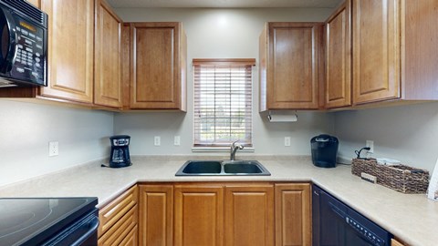 a kitchen with wooden cabinets and a window