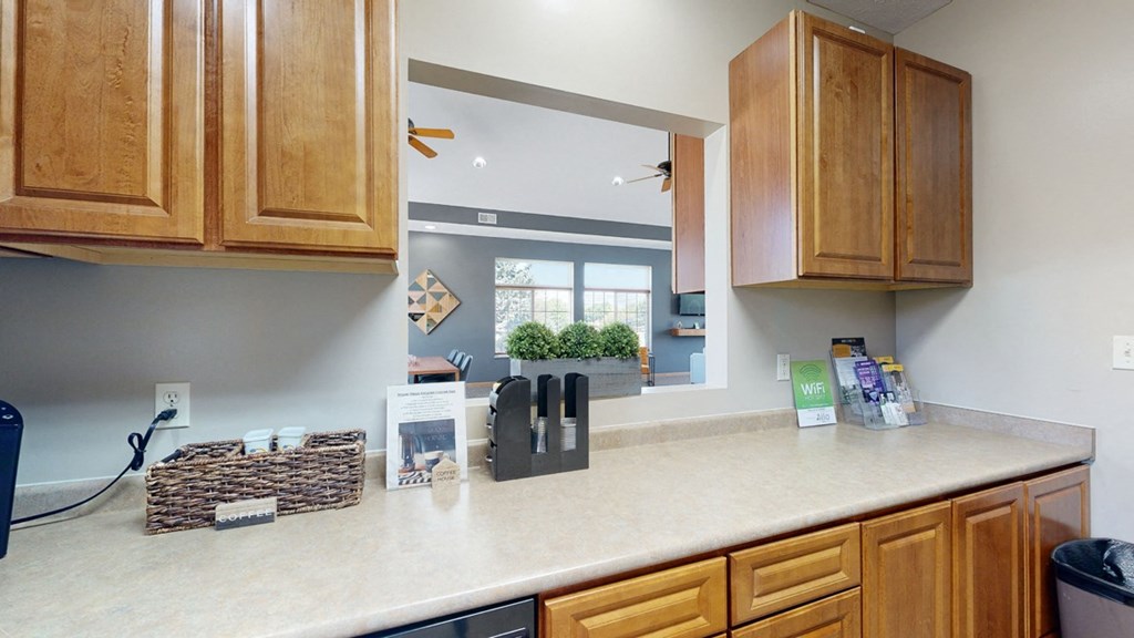clubhouse kitchen with wooden cabinets and a counter top