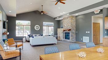 clubhouse living room with gray walls and a stone fireplace